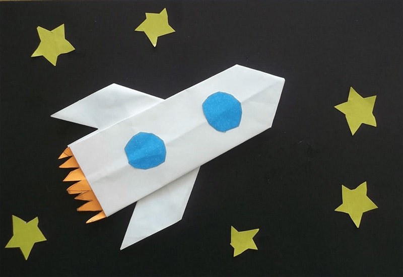 Простая аппликация на картоне из цветной бумаги на тему космоса
